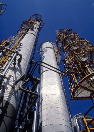 "oil refinery chimneys, breathtaking views are lost in the deep blue sky."